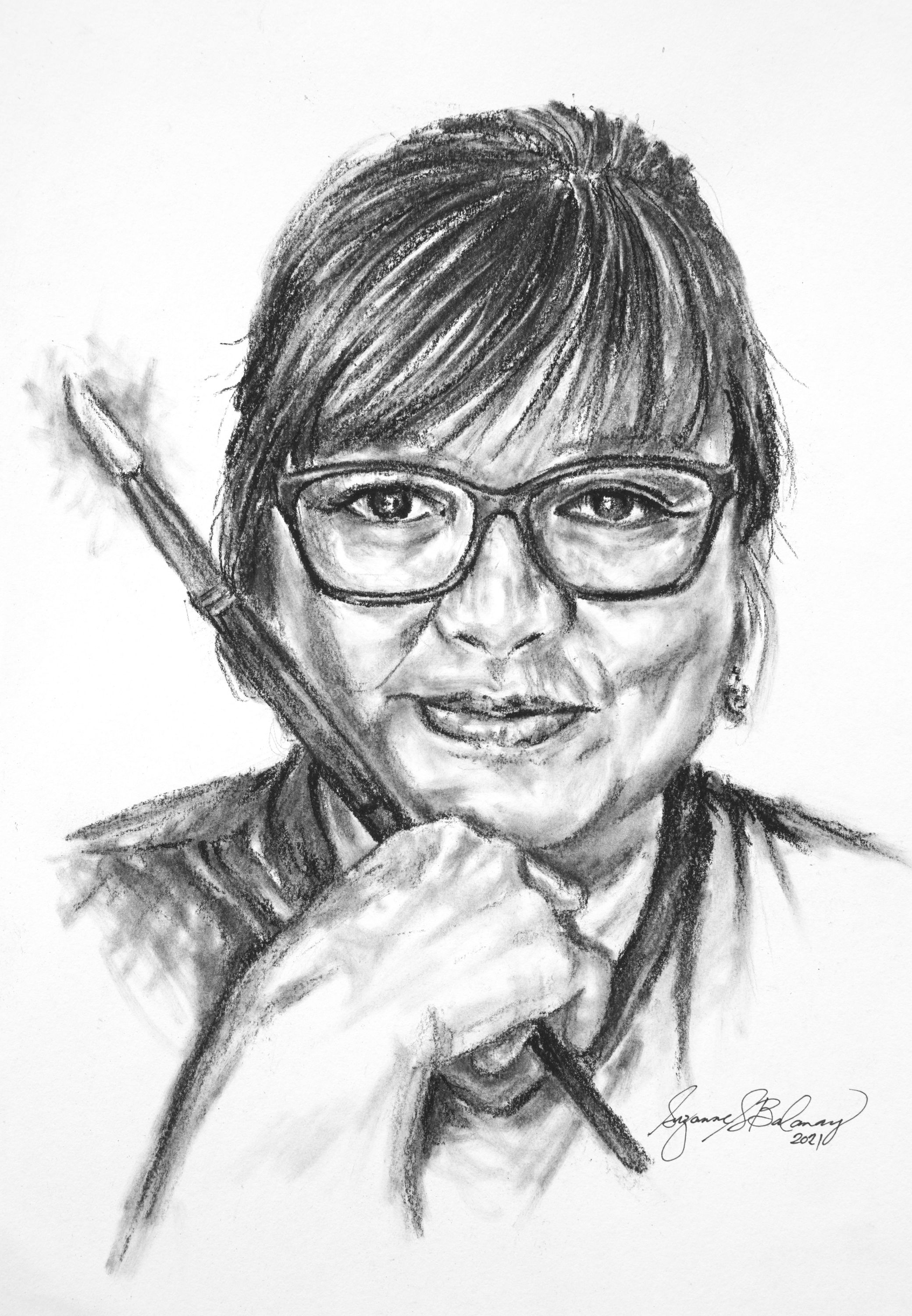 charcoal portrait drawing of woman in glasses holding a paint brush for drawing art class