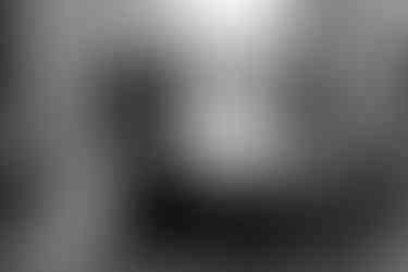 Black and white image of a family sitting on blocks, looking casual