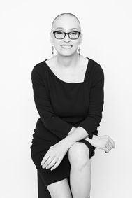 Elegant black and white, woman with short gray hair, beaming her authenticity.