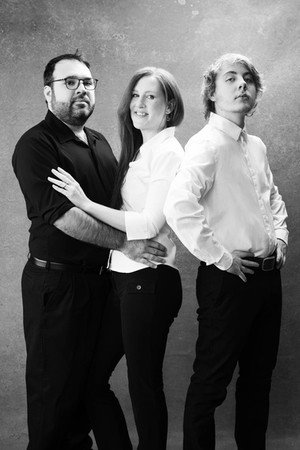 Black and white image of a family with adult son.