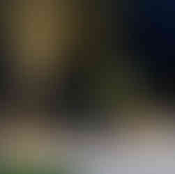 Close-up of retaining wall footing and drainage layer with gravel backfill and ag-pipe for proper water management.