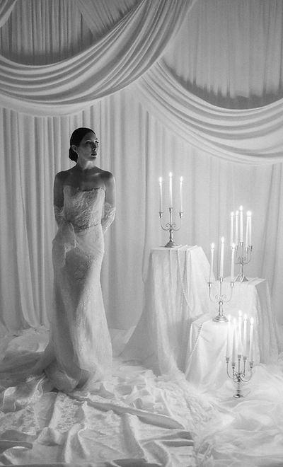 Novia elegante en vestido de encaje con velas, fotografía editorial de boda en blanco y negro