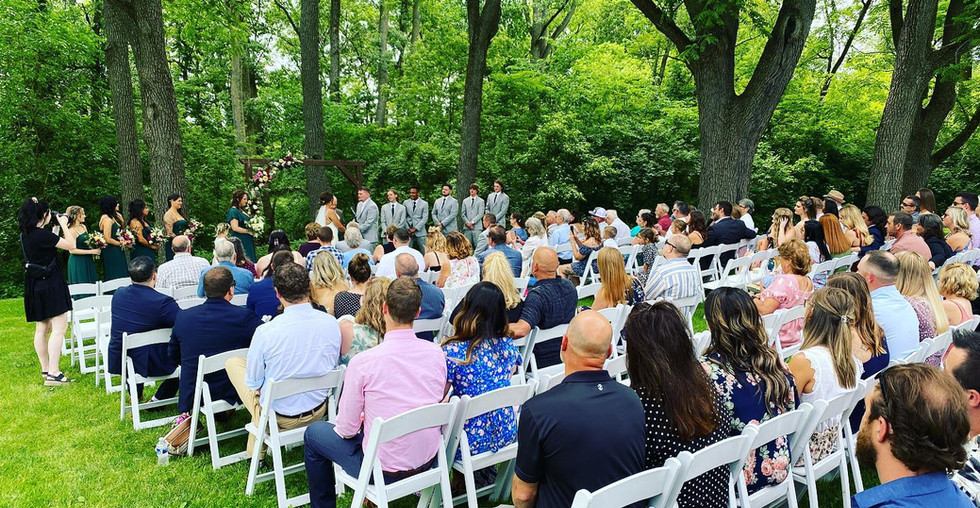 Audience listening to Outdoor Wedding near large trees