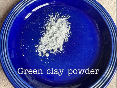 Green clay powder on a blue plate 