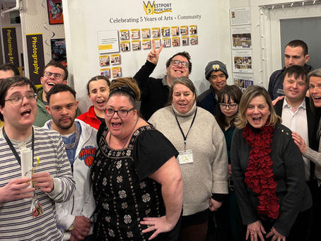Image of a grouop of people laughing and posing