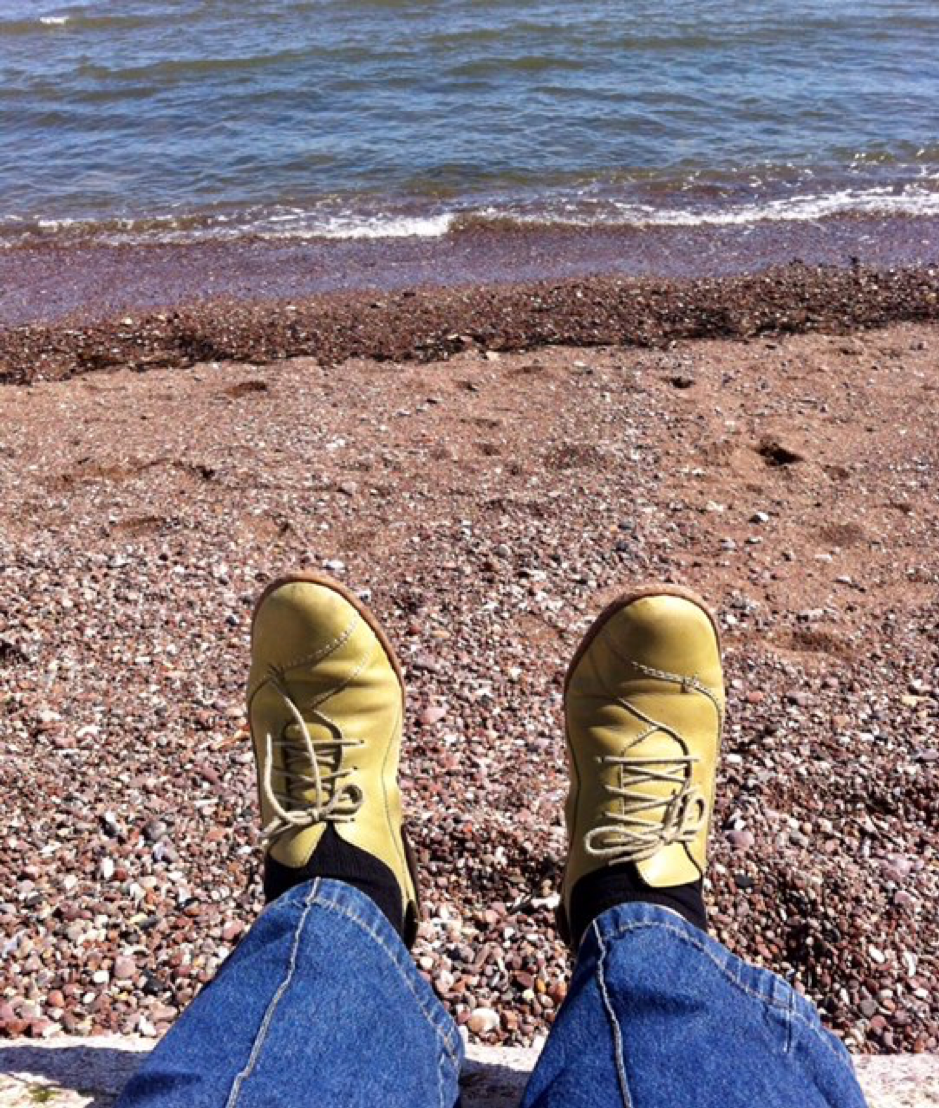 Feet in boots on a beach