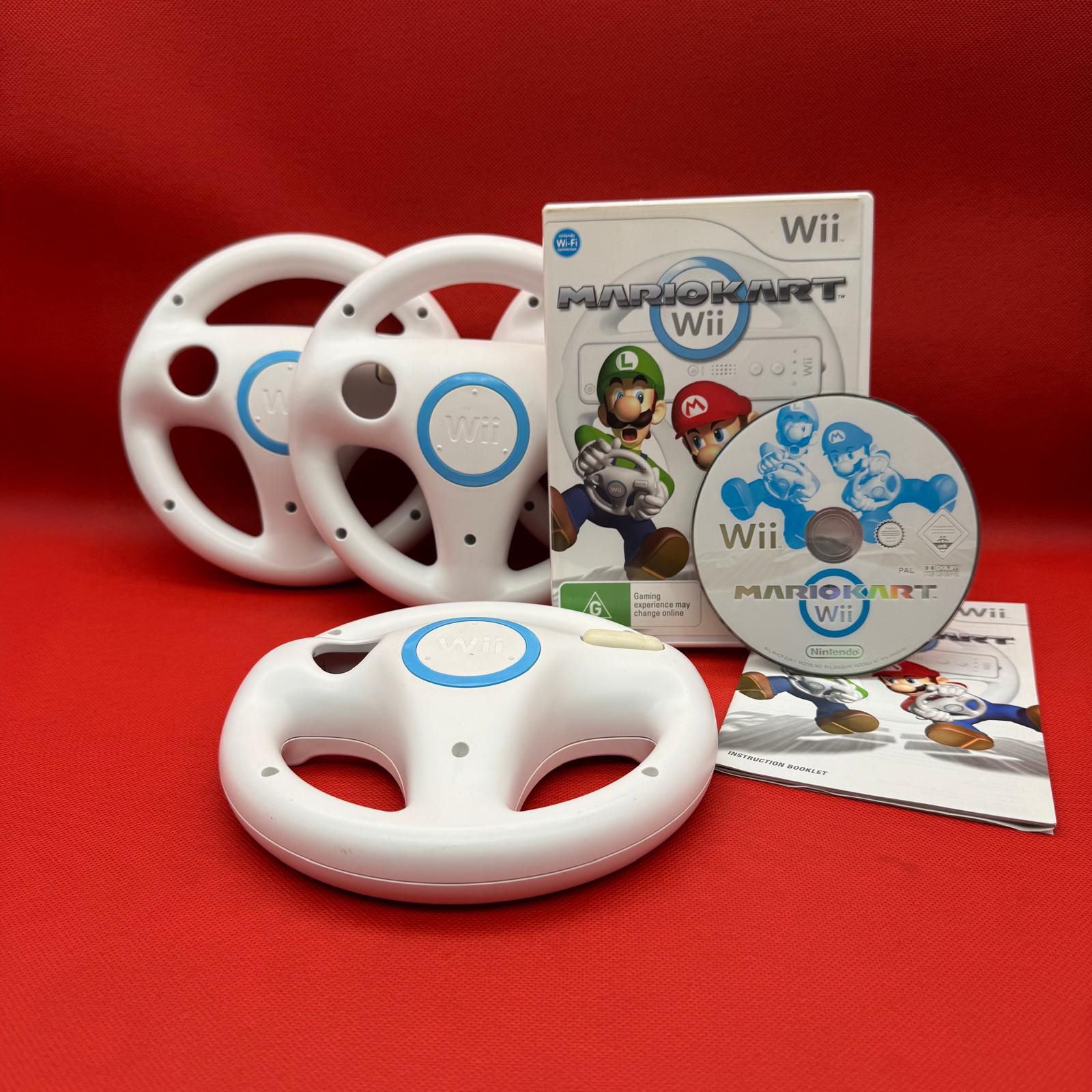 Mario Kart Wii game disc with two Wii steering wheels