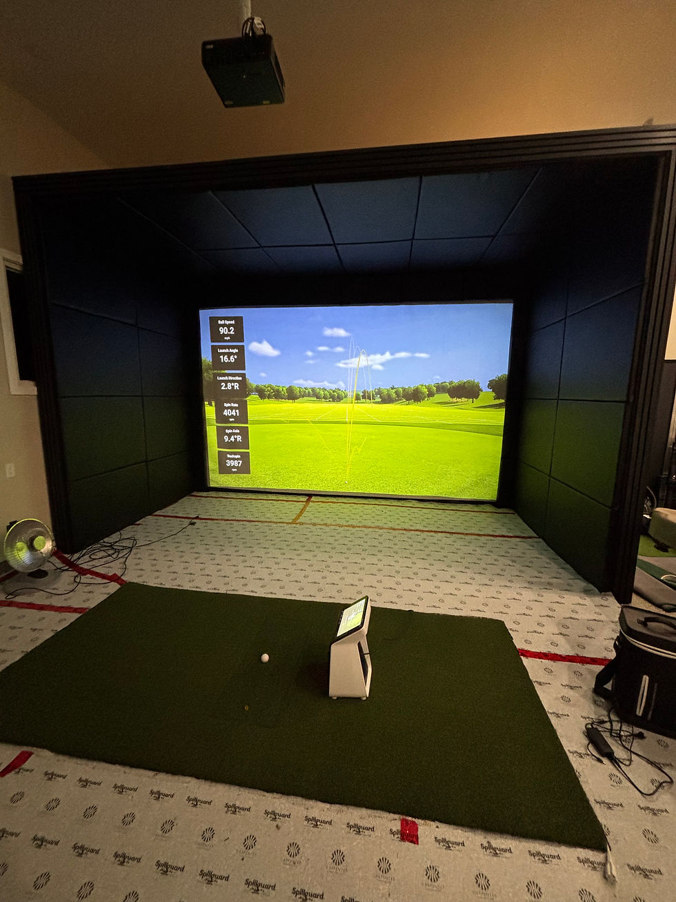 Close up of high quality golf simulator enclosure materials including acoustic panels and turf