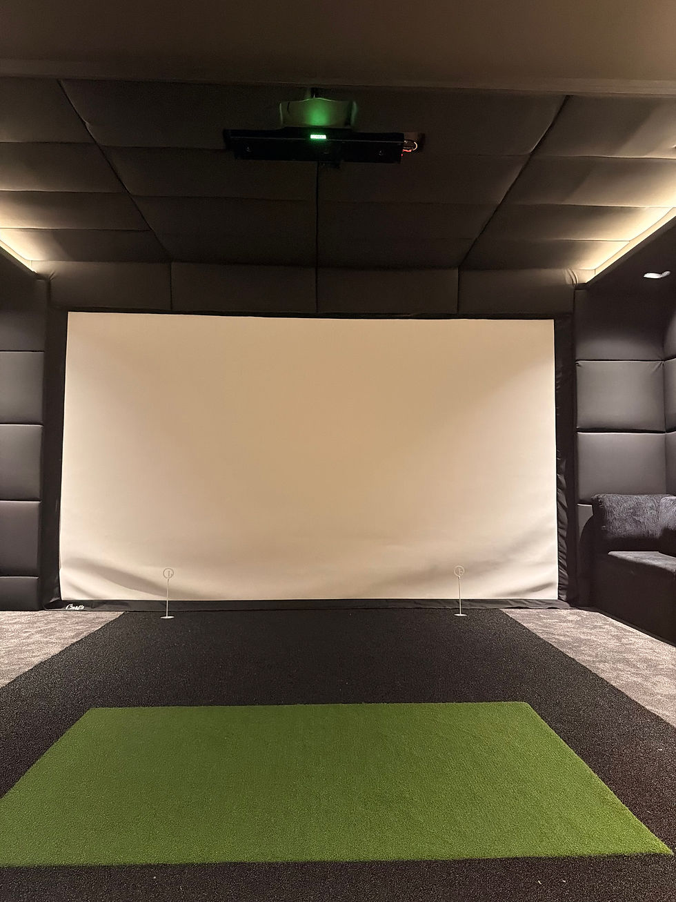 Basement golf simulator installation with padded frame and turf hitting area
