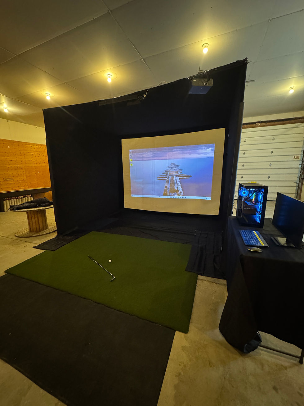 Close-up of overhead projection and sensor technology in a golf simulator enclosure