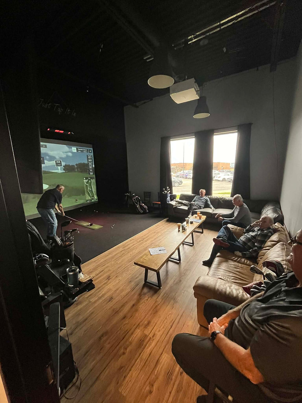 Residential golf simulator enclosure build with dark padded walls and impact screen