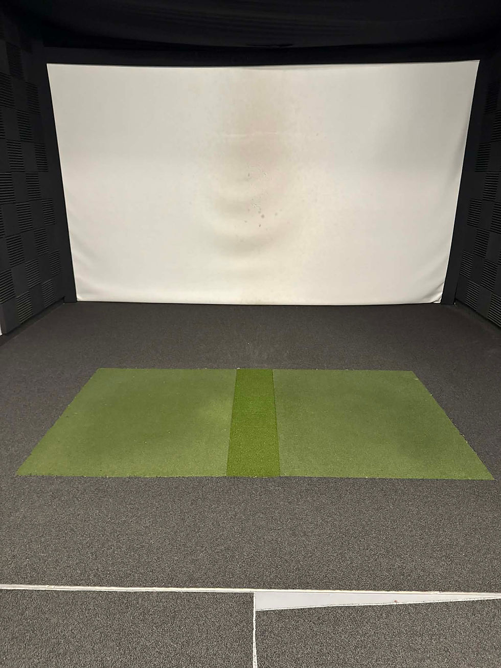 Golf simulator room showing impact screen and side wall padding detail