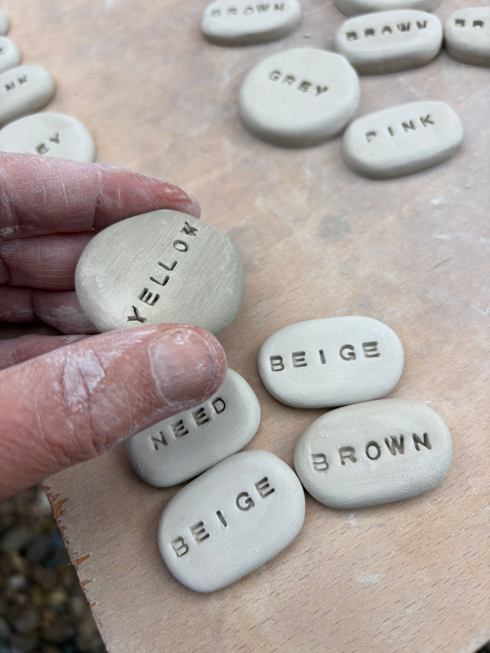 Making in white earthenware clay word brooches