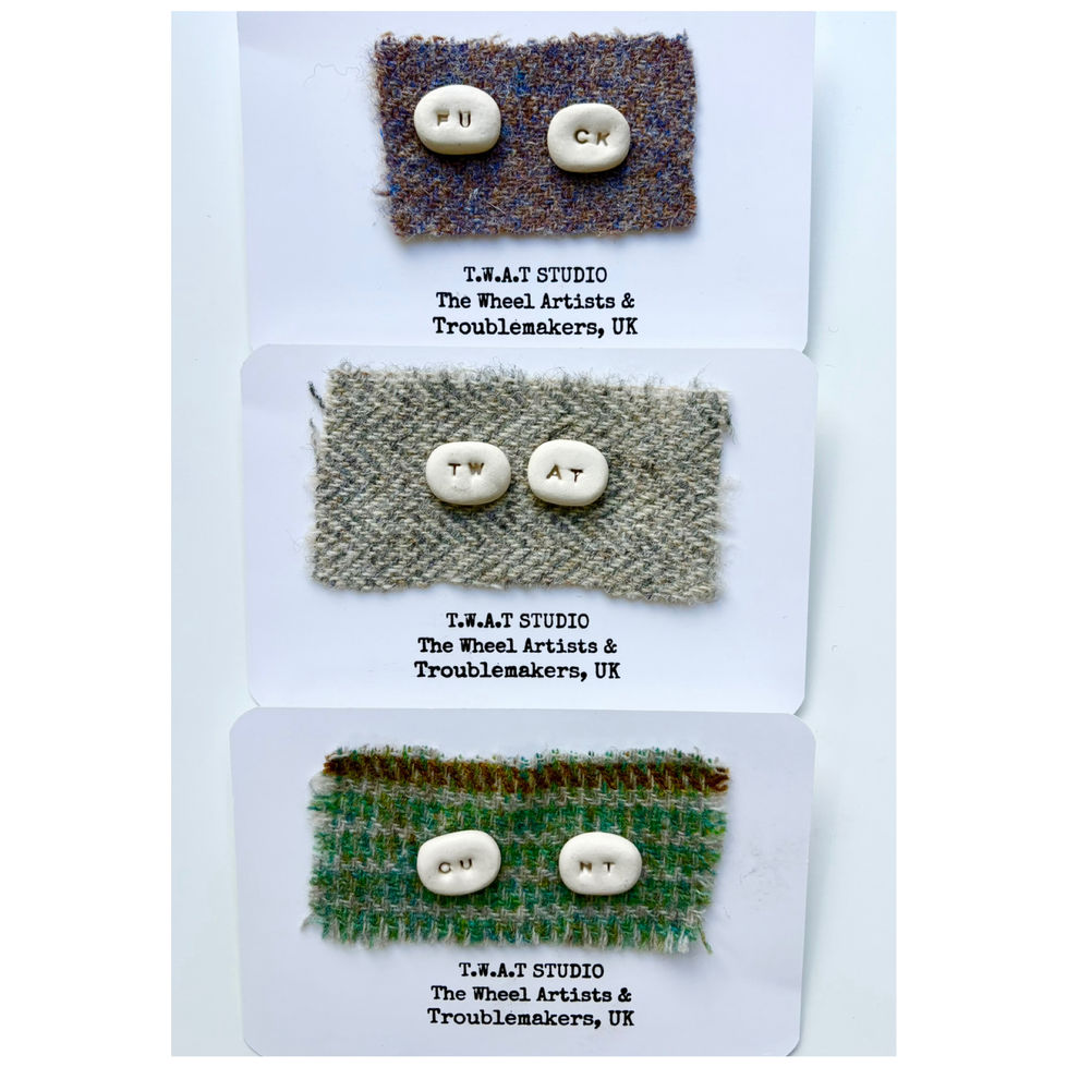 collection of handmade ceramic earrings on tweed remnants