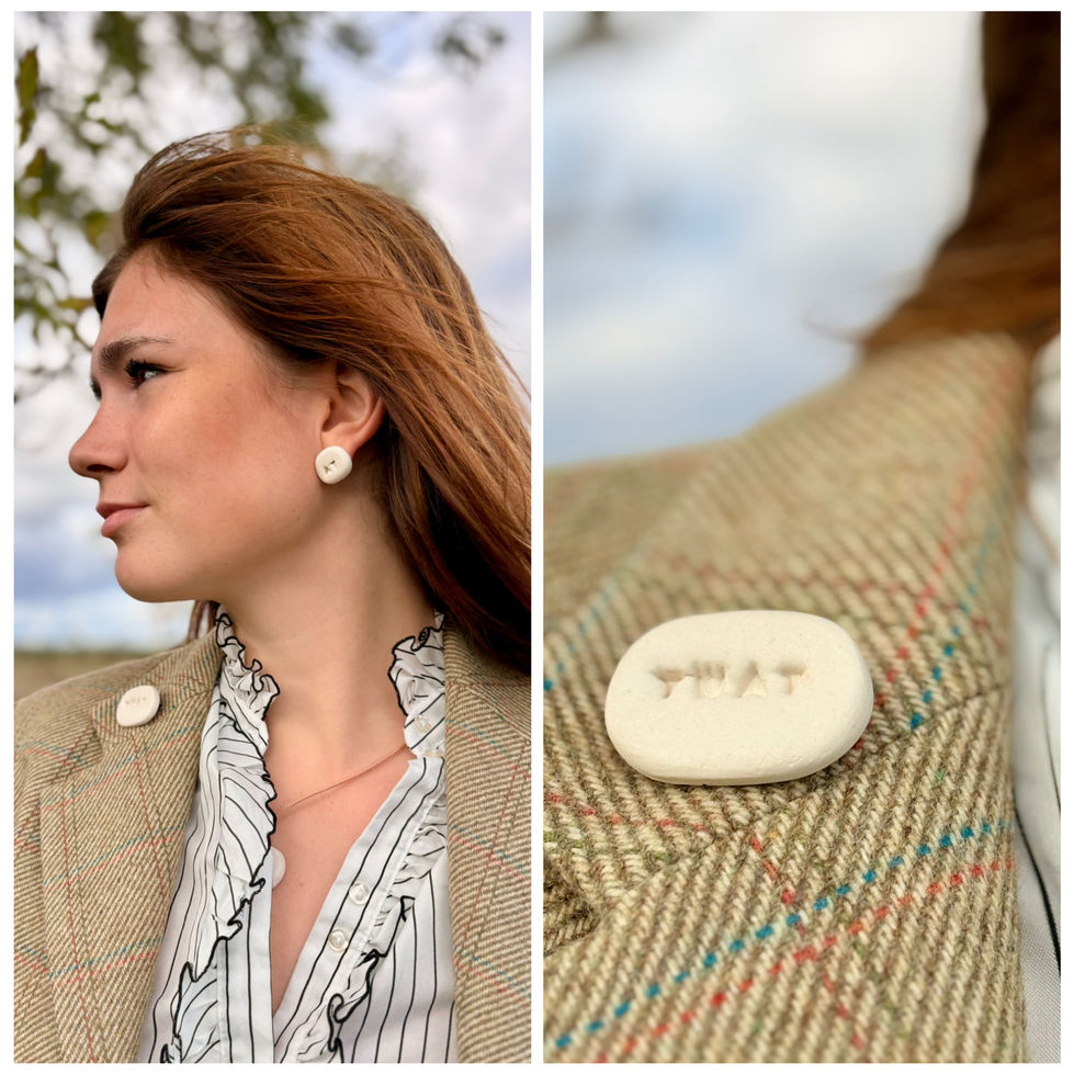 Handmade ceramic word brooch worn on tweed