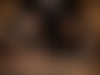 Leader in a tailored suit gesturing over a polished bar with professional tools, symbolizing leadership excellence, discipline, and attention to detail in hospitality service.