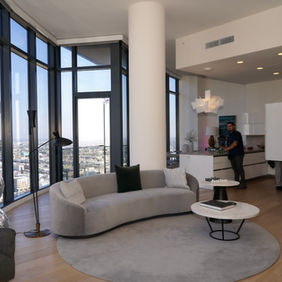 Modern living room at Circa in Downtown Los Angeles with city views through large windows.