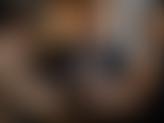 Leader demonstrating care-driven leadership by engaging in a warm, attentive conversation with team members in a hospitality-focused professional setting.