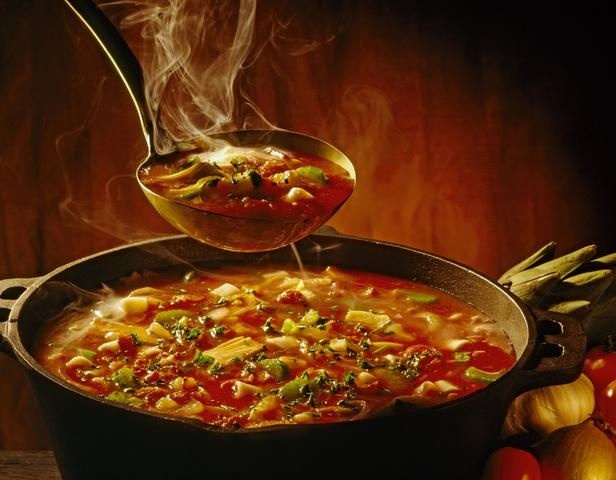 A boil of delicious hot soup. Steam coming from it.