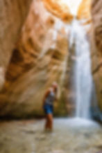 Couple standing in front of waterfalls at Ashdown Gorge in Cedar Canyon