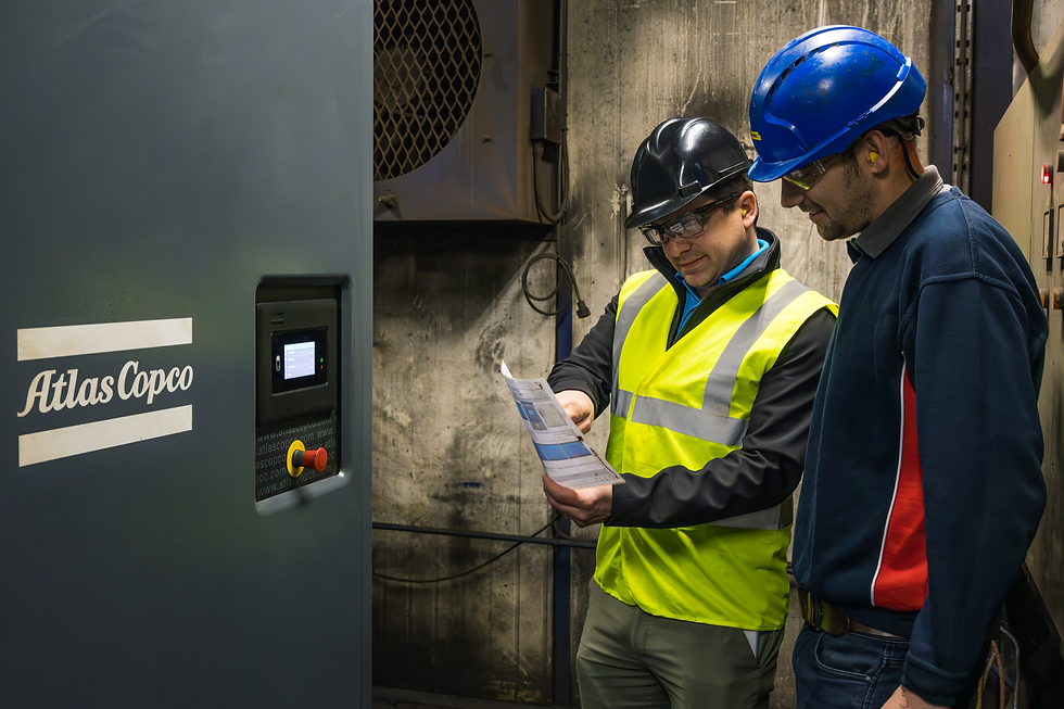 An engineer explaining compressor system to worker