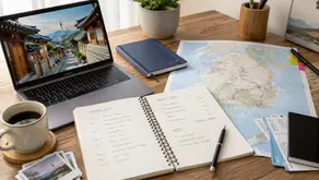 Travel planning workspace with a Korea route map, itinerary notebook, budget notes, and laptop