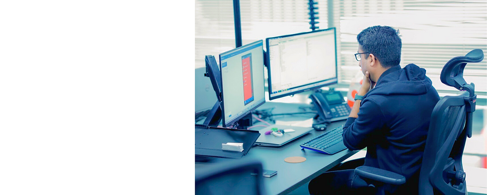 Man reading from 2 computer screens