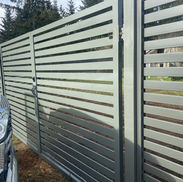 Grey horizontal metal driveway gate installation on Vancouver Island.