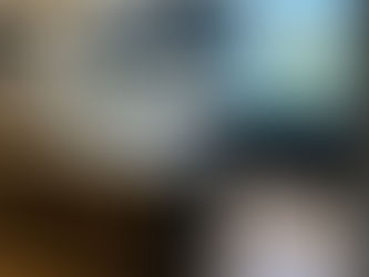 Bespoke classic-style navy blue kitchen with panelled cabinetry, silver handles and white Corian worktops, built by First Manufacturing Ltd.