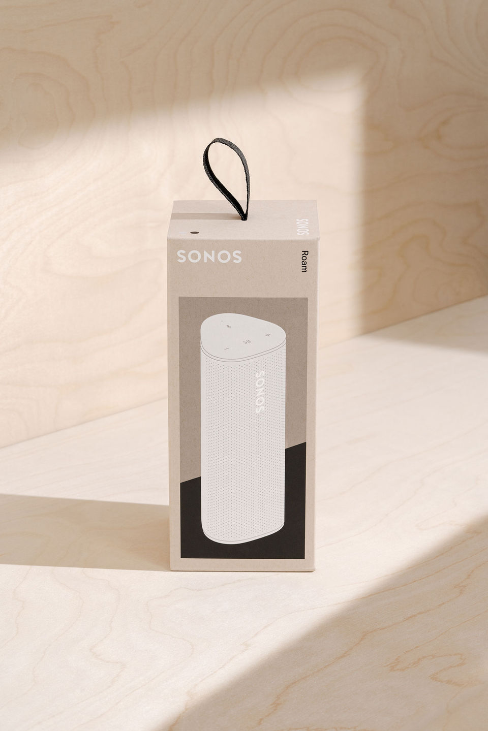 sonos-roam-packaging-white-hero-on-wood-2500