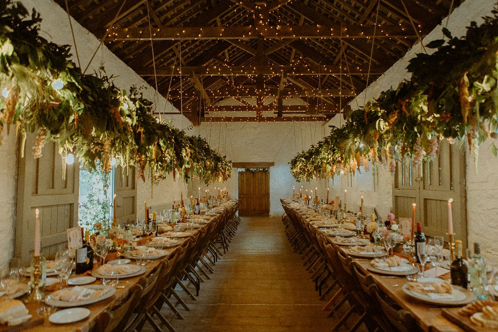 A stunning barn is decorated for a wedding breakfast and reception