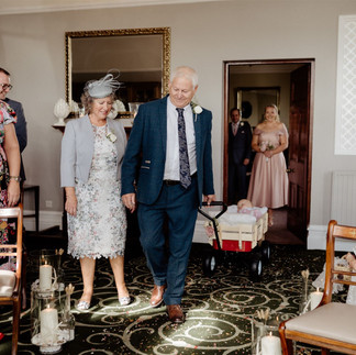 The groom's parents arrive with their grandson