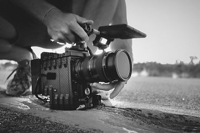 Video production videographer holding camera low
