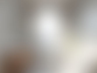 Modern luxury bathroom with oversized window, stone tiles and bright natural lighting