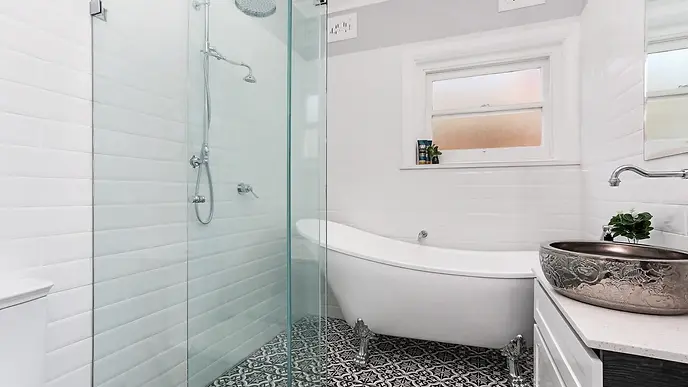 Luxurious bathroom renovation in Kingsgrove featuring a modern walk-in shower, wall-hung vanity, and sleek floor-to-ceiling tiles by Mr Bathrooms Sydney