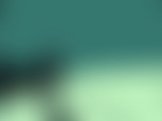 A man in a black suit stands on a grassy hill under a teal sky, casting a long shadow. The scene feels solitary and contemplative.