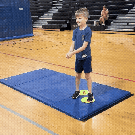A gif of a young boy practicing passing a volleyball.