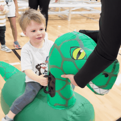 A gif of a fun activity on the volleyball court using inflatables animals.