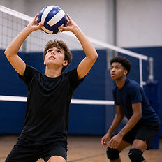 Boys volleyball players practicing setting at the net.