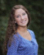A profile picture of Coach Rebecca Moore against an outdoors background.