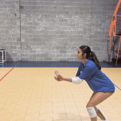 Three girls volleyball players practicing passing, setting, and attacking. 