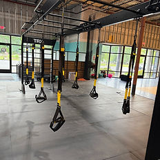 A TRX machine with several handles or grips hanging down.