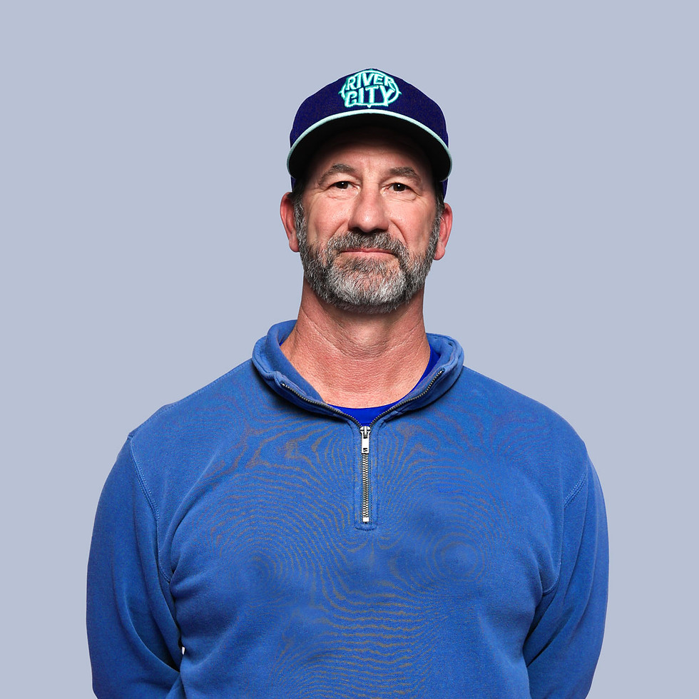 A profile picture of Volleyball Coach Kevin Pond in a dark blue shirt wearing a hat that says River City.