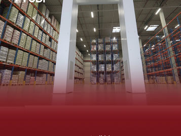 Warehouse interior with tall RFID Gate, shelves stacked with boxes. Red gradient on left. Text: TUDI, www.tudi.id.