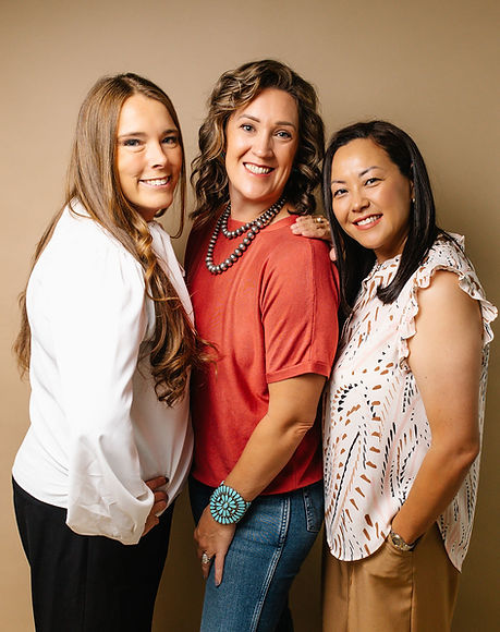 smiling real estate agents from helpful housewives homes team in green valley, az
