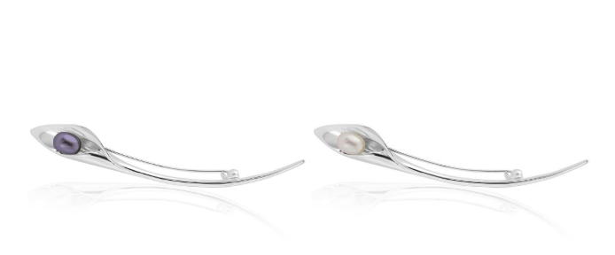 Two sleek silver hairpins with curved design, each cradling a pearl—one purple, one white. Set against a white background.