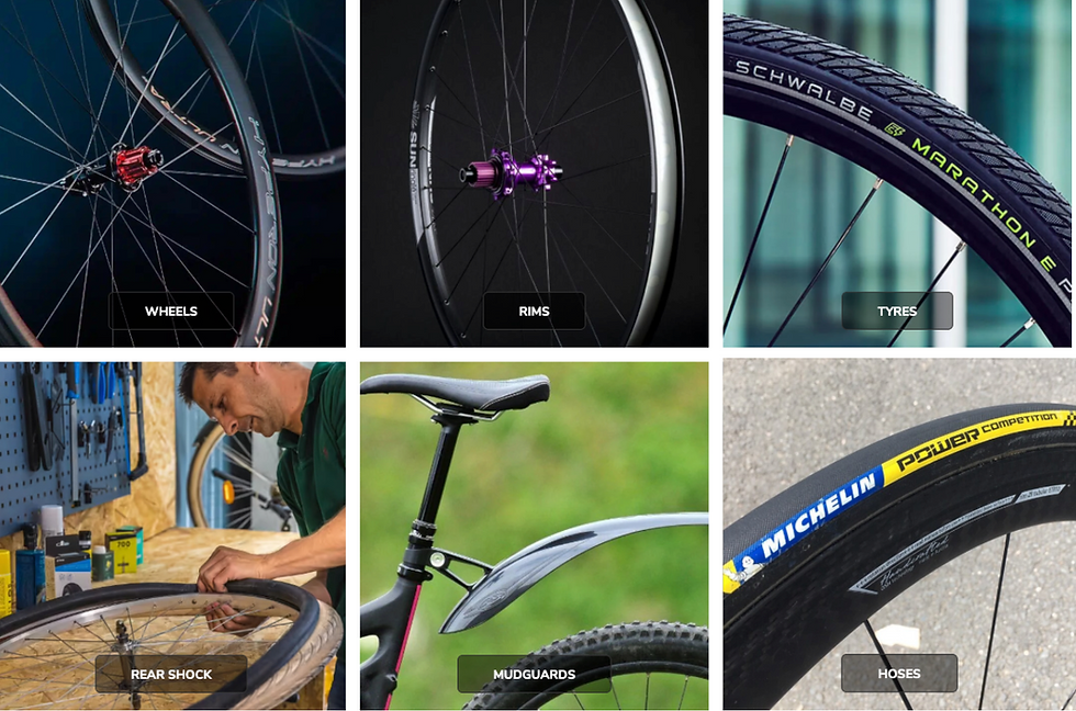 Bicycle components montage: wheels, rims, tires. Person fixing a wheel in workshop. Black mudguards on a bike. Bright tire branding.