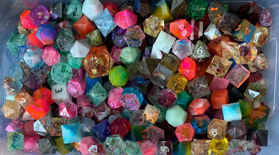A box filled with many colorful, handmade TTRPG/D&D dice (made by The Heady Bard).