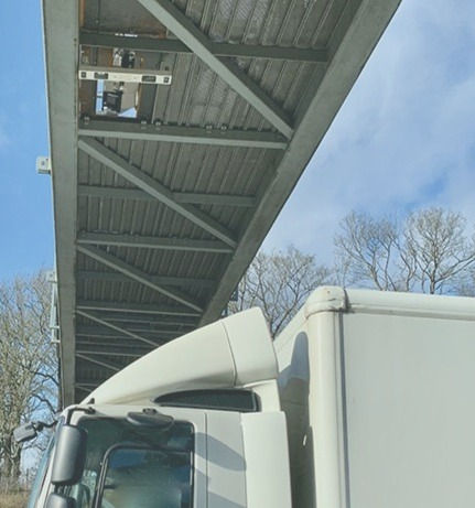 Eye-level view of roadside diesel truck undergoing emissions monitoring