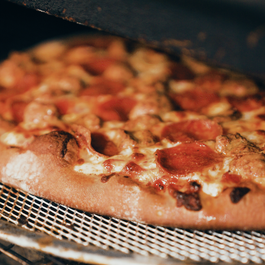 PitzaPizza Steaming Pepperoni and Italian Sausage coming out of the oven.gif